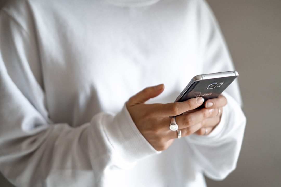 person holding smartphone giving voice command to AI assistant app