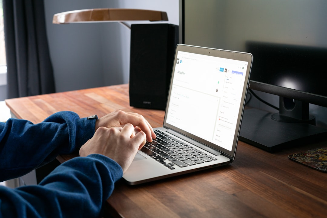 person managing tasks and calendar on laptop at desk