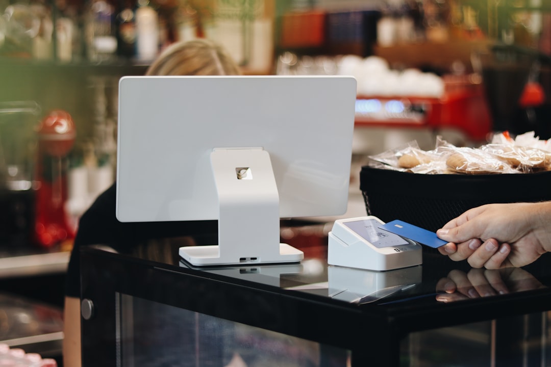 hand swiping credit card at store checkout