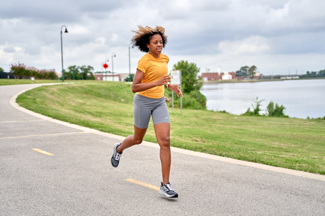 woman running outdoors wearing fitness tracker smartwatch